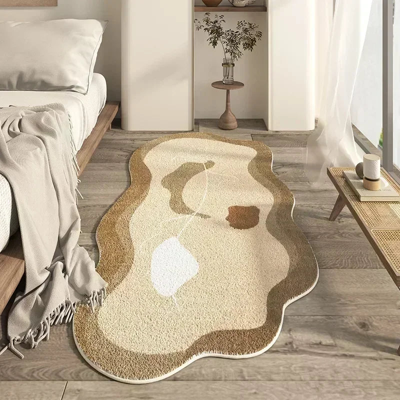 A beige and brown irregular area rug with a white line design placed on a light wood floor.