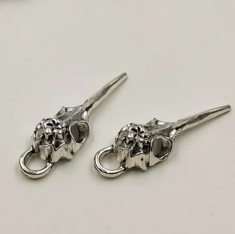 A set of five silver gothic skull and crow head charms for jewelry making