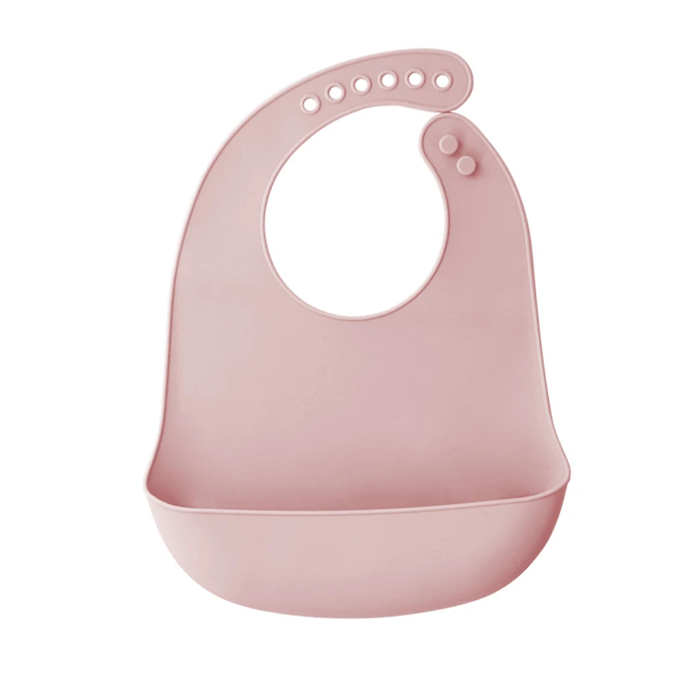 A pink ultra-thin silicone baby bib with a catch pocket for feeding