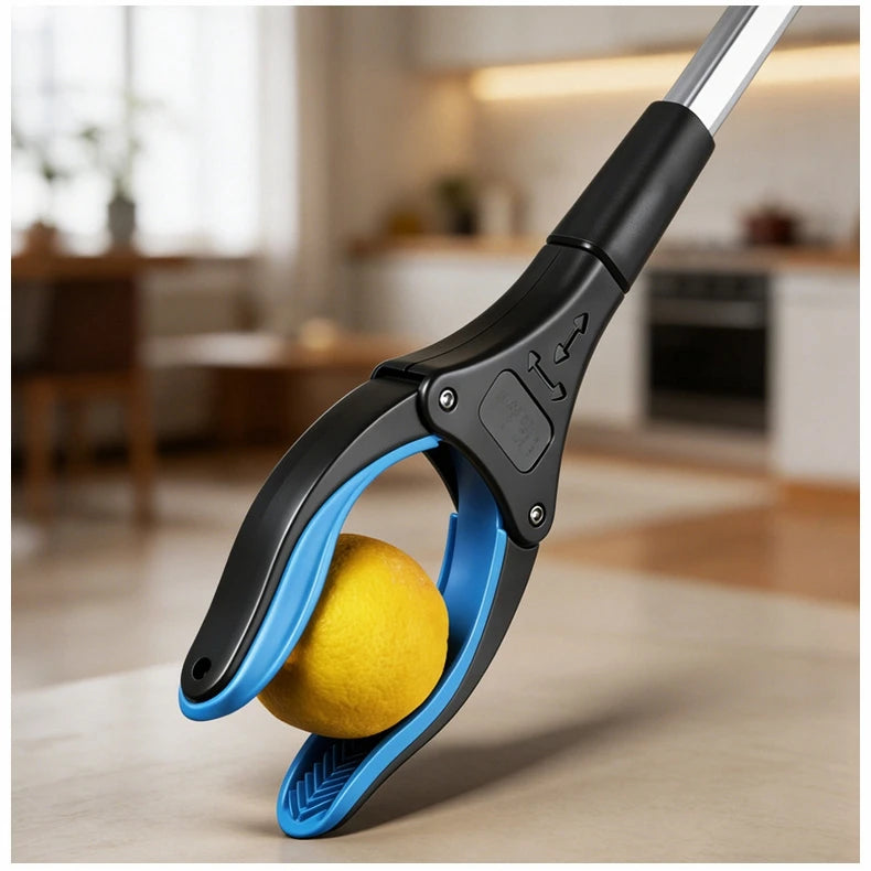 A close-up of a blue and black foldable reacher grabber tool with a yellow ball being picked up on a wooden surface.