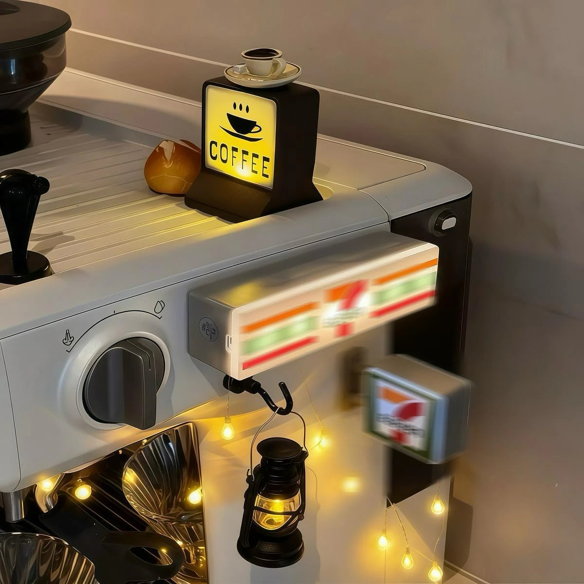 A miniature glowing storefront fridge magnet with a night light is displayed on a white appliance.