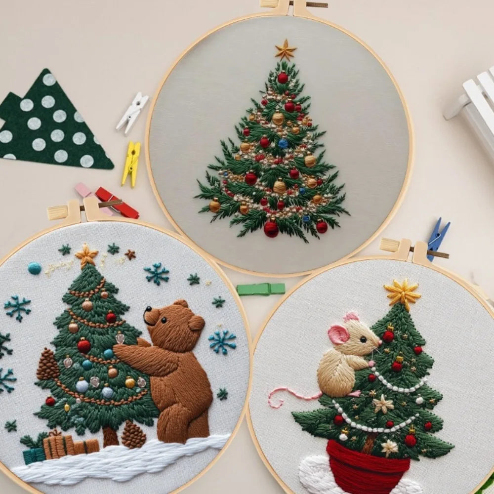 Christmas embroidery kit featuring a handcrafted set of knitted and embroidered Christmas trees and bears on a light backgrou