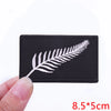 Black embroidered iron-on letter patch featuring a white fern leaf design.