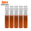 Five vials of orange liquid solution for a fruit fly trap kit with pheromone lure