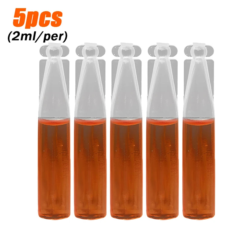 Five vials of orange liquid solution for a fruit fly trap kit with pheromone lure