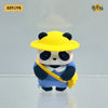 A blind box figure of a panda wearing a yellow hat and blue overalls.