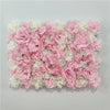 A dense wall panel of pink and white silk rose flowers for weddings and events.
