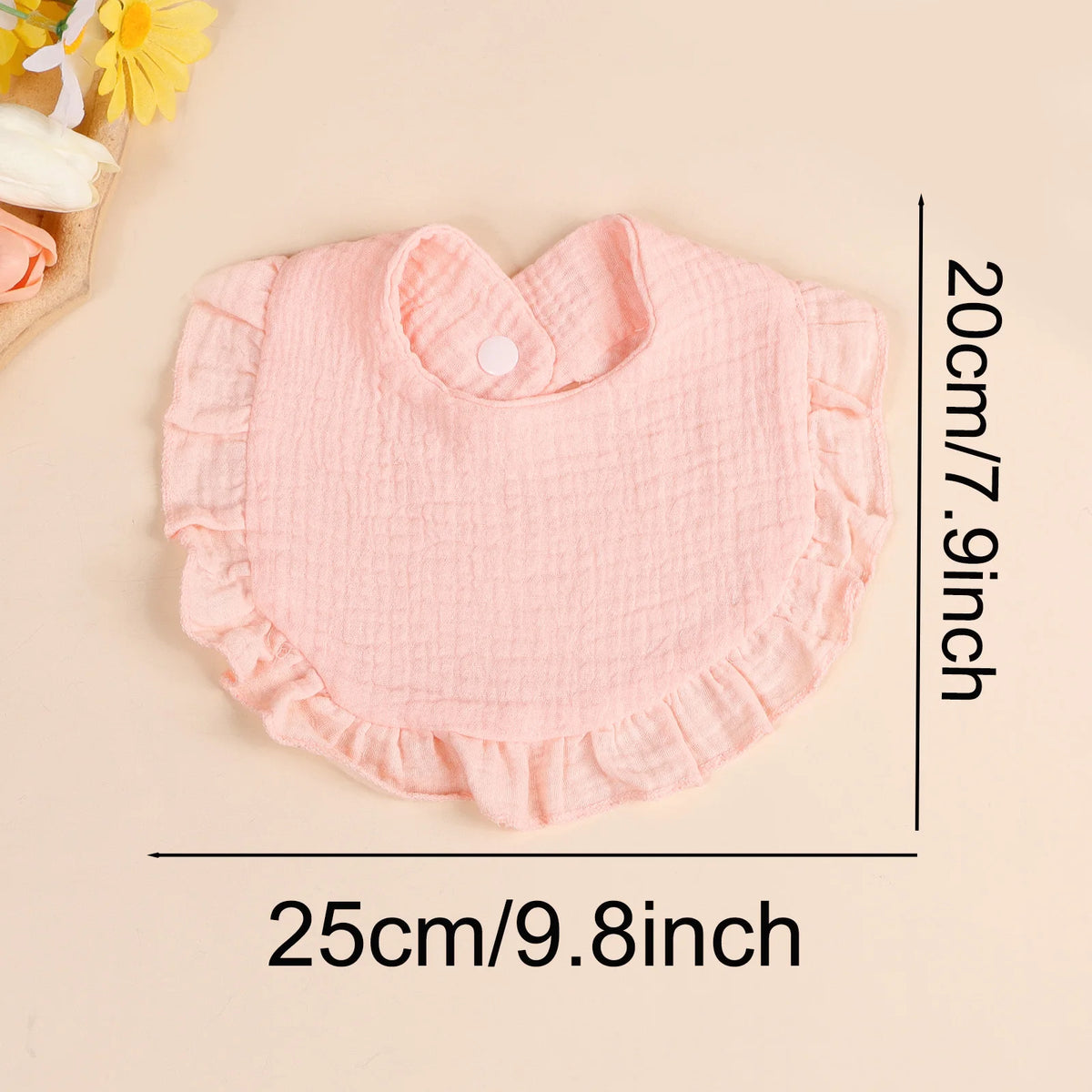 A pink soft cotton ruffle bib is shown flat, measuring 20cm wide by 25cm long.