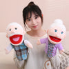 A young woman is holding two soft plush hand puppets, one with a white beard and another with white hair.