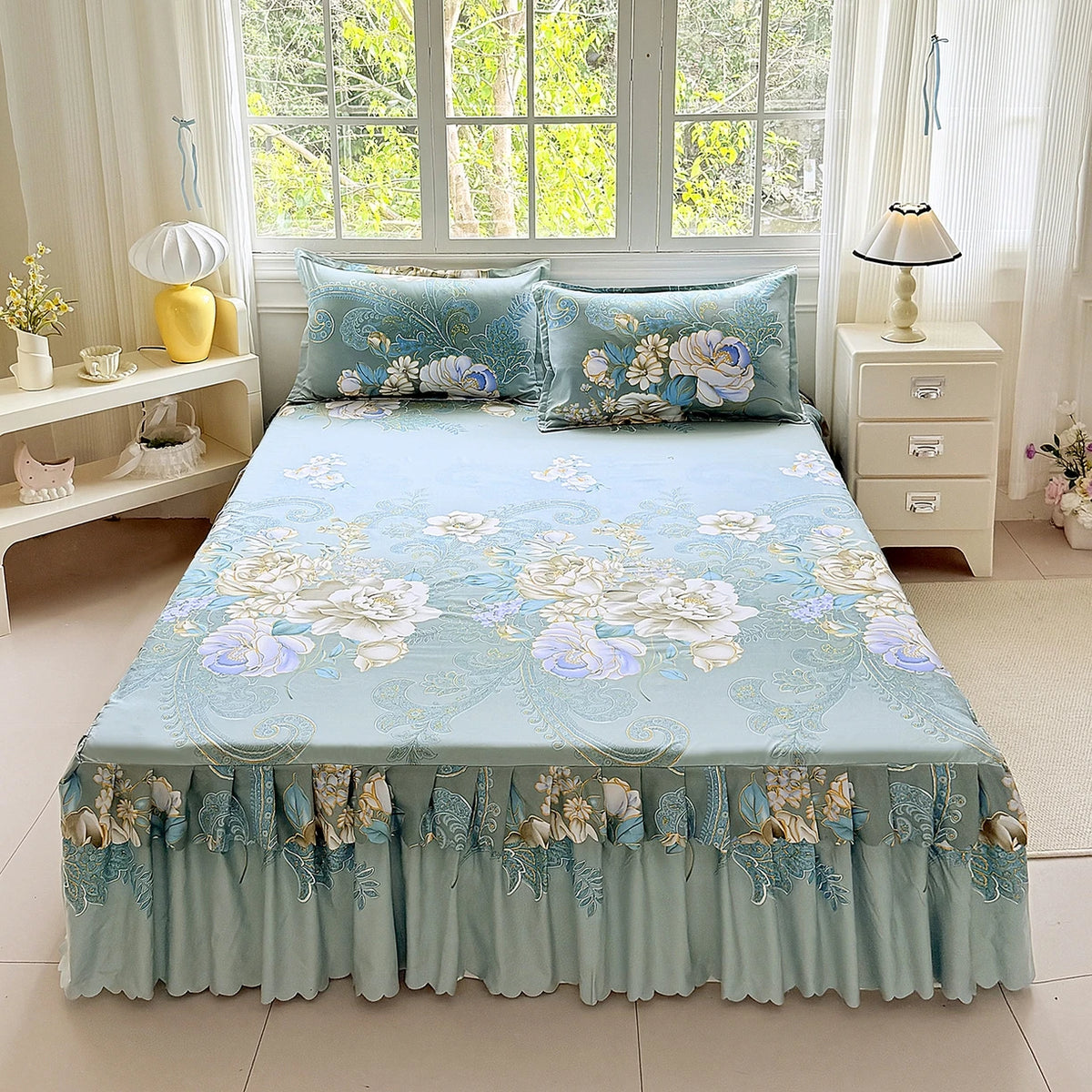 Light blue floral print bed skirt and pillowcase set displayed on a bed with sheer curtains.