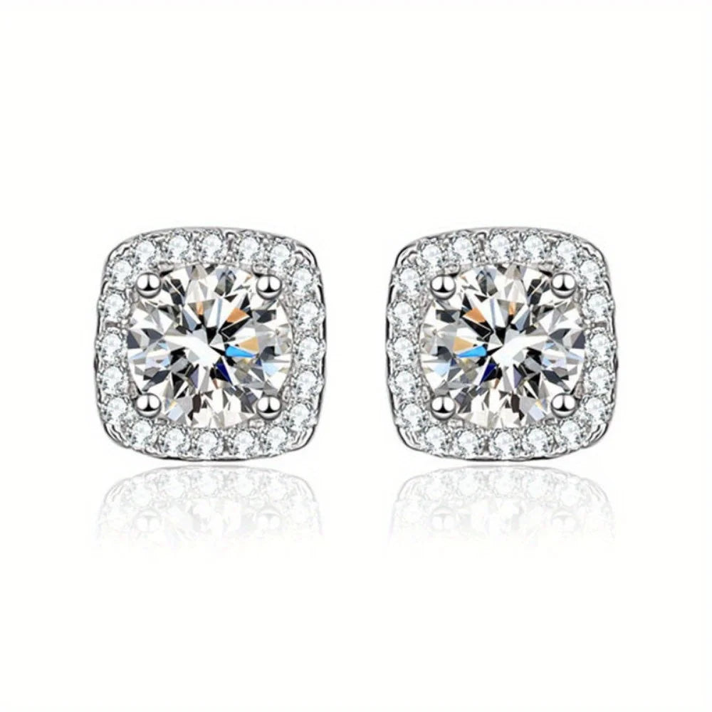Pair of silver-tone cubic zirconia stud earrings with round brilliant stones.