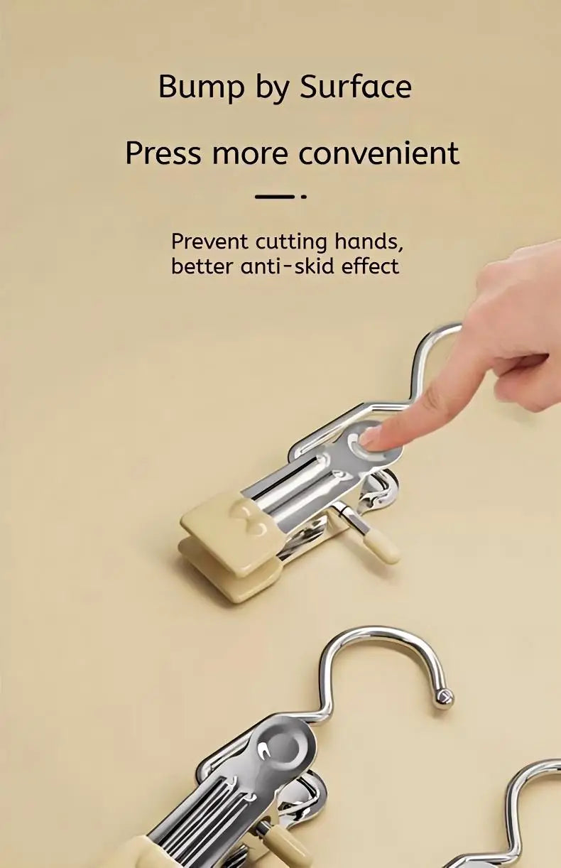 A hand is pressing a bump by surface feature on stainless steel clothespins to prevent cutting hands and improve anti-skid ef