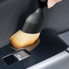 A black soft-bristle cleaning brush is shown inside its protective case, ready for use.