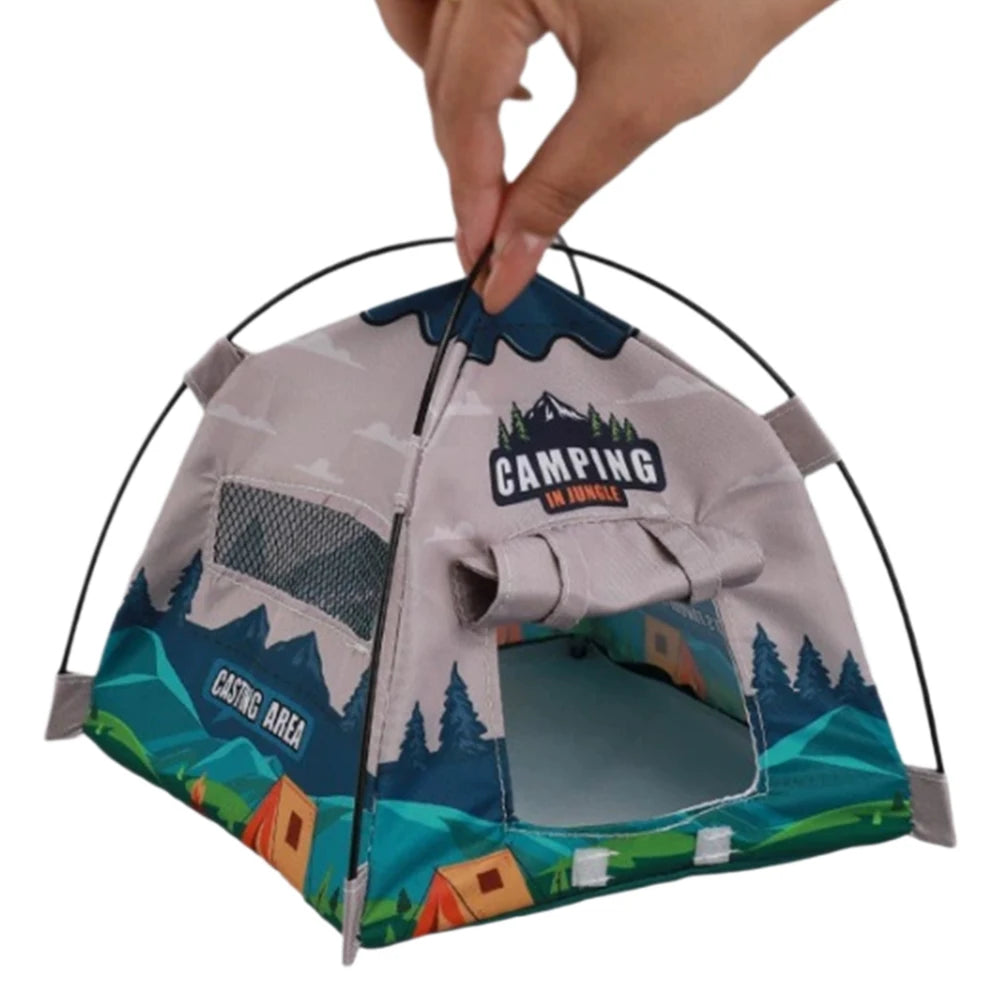 A hand is holding a camouflage-patterned fabric accessory shaped like a tent or dome for fashion dolls.