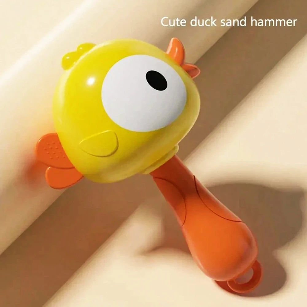 A yellow duck sand hammer toy with a large eye and orange body is shown against a light background.