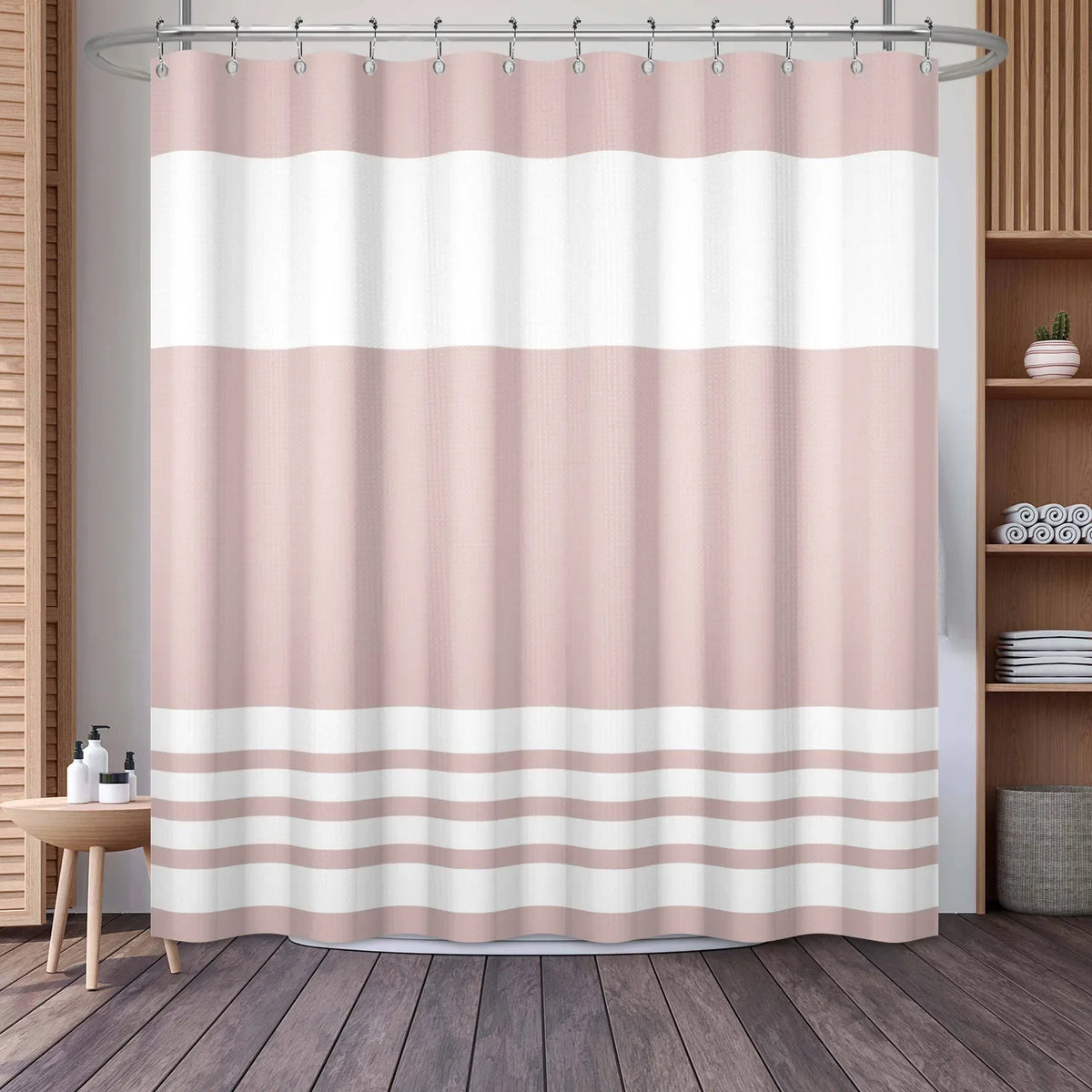 A beige and white striped waffle weave shower curtain hanging on a rod.