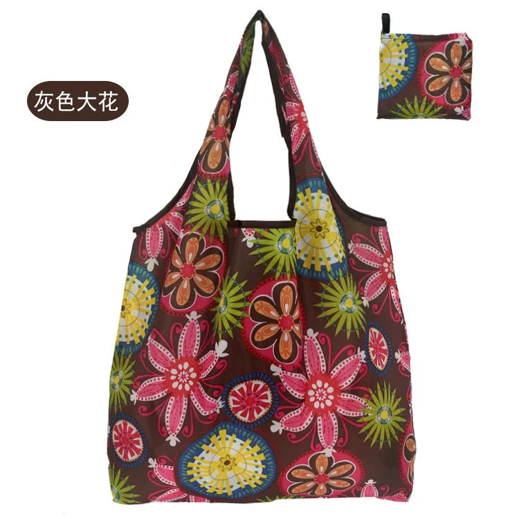 A reusable nylon shopping tote bag featuring a floral pattern in shades of pink, orange, and green.