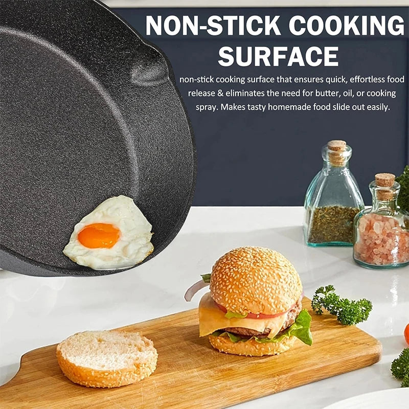 A non-stick cooking surface is shown next to a fried egg and a hamburger on a wooden cutting board.