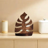 A rustic wooden wall-mounted storage rack with plant decor sits on a light wood shelf.