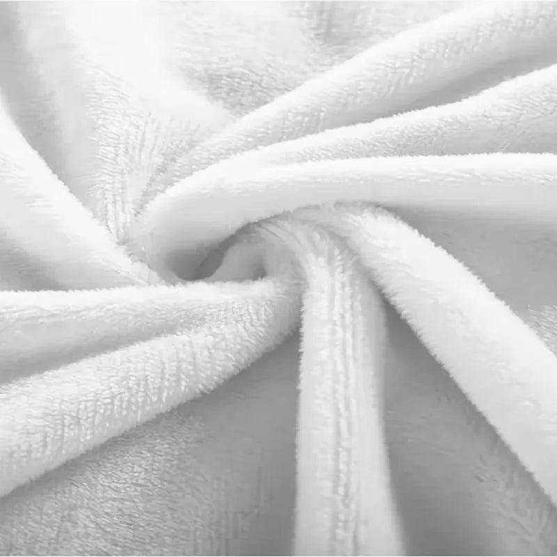 A close-up of a white flannel throw blanket folded and draped softly.