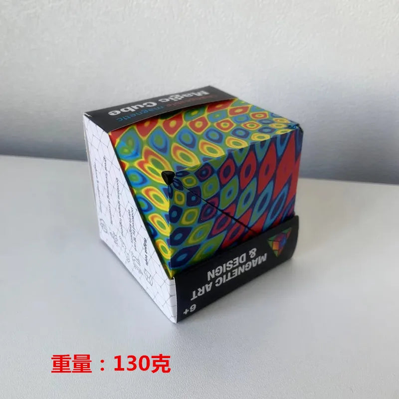 A box containing a colorful magnetic geometry cube puzzle toy set with a red and black label.