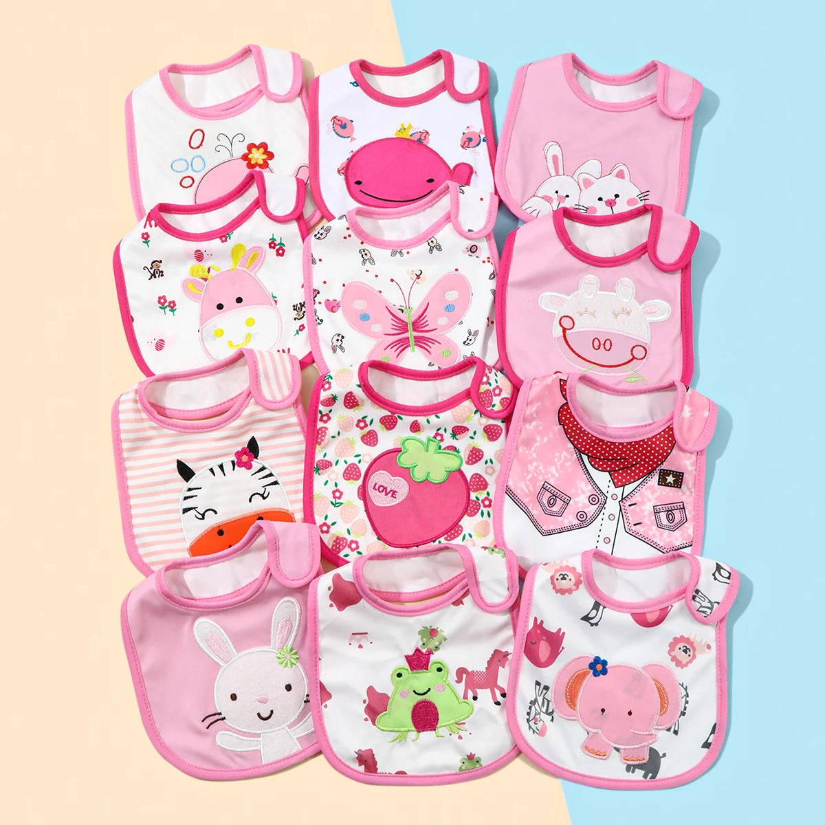 A set of pink and white waterproof baby bibs and burp cloths featuring various cartoon animal prints.
