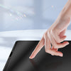 A hand applies a nano optical adhesive layer to a paper-feel matte screen protector on an iPad.