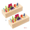 A wooden geometric shape and color sorting box filled with colorful wooden shapes for toddlers.
