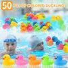 Fifty colored rubber ducklings floating in blue water for bath time or party favors