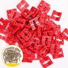 A pile of red PVC outlet spacers used for secure electrical installation.
