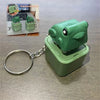 A green frog sound pendant keychain is displayed next to a laptop and a similar product.