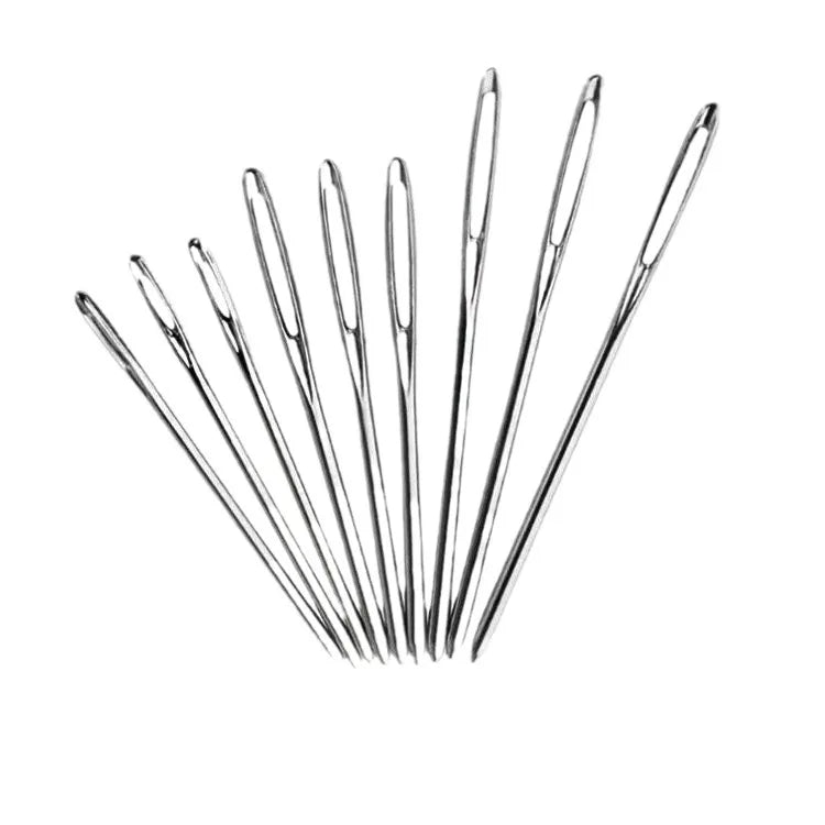 A collection of large eye sewing needles for yarn, embroidery, and beading arranged diagonally.