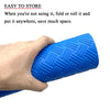 A hand is holding a bright blue, textured non-slip swimming pool ladder mat.