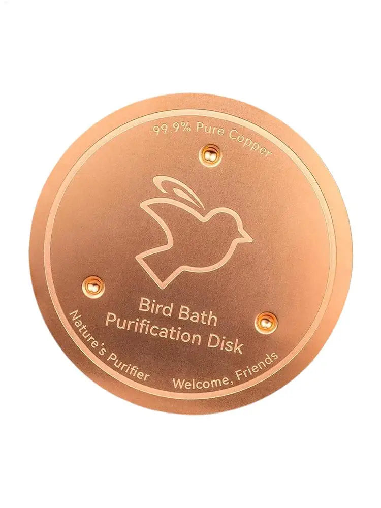 A round, copper purification disk for a bird bath, featuring a silhouette of a bird and text indicating 99.9% pure copper.