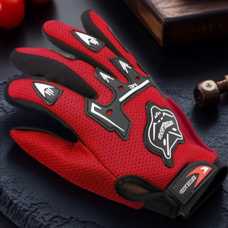 A pair of red and black full finger nylon riding gloves with anti-slip grip resting on a dark surface.