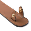 A brown genuine leather handbag handle wrap and shoulder pad with brass hardware.