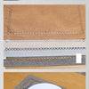 A set of three linen embroidered placemats in beige, tan, and gray, with a square placemat featuring silverware on a wooden t