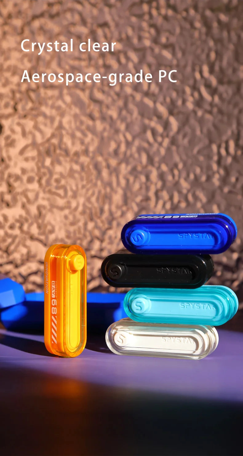 A collection of clear and colored metal fidget sliders, including blue, black, orange, and light blue variants.