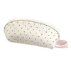 A shell-shaped pencil case in off-white fabric with small black polka dots and a pink strap.