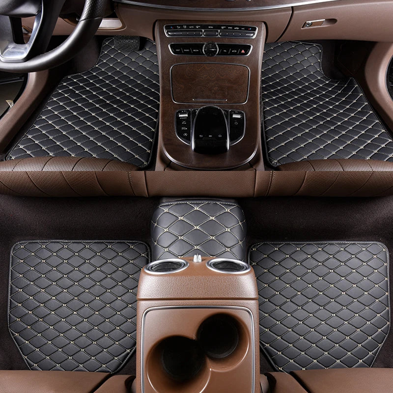 Interior view of a car with brown quilted leather floor mats and trim.