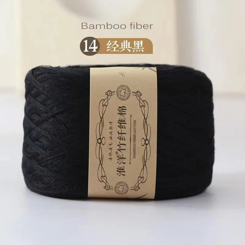 A dark black spool of bamboo fiber yarn labeled for knitting and crochet projects.