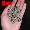 A hand holds a set of 15 glow-in-the-dark acrylic dice for night games.