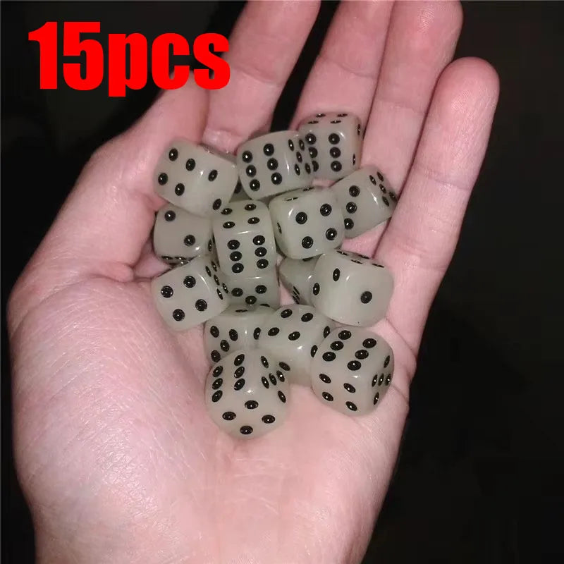 A hand holds a set of 15 glow-in-the-dark acrylic dice for night games.