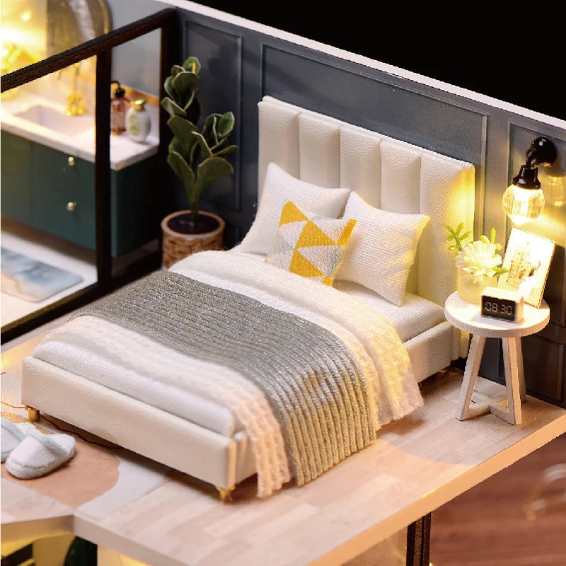 A white upholstered bed with a padded headboard and bedding is shown in a modern bedroom setting.