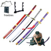 A collection of cosplay swords, including a katana and various bladed weapons, next to a figure of Roronoa Zoro.