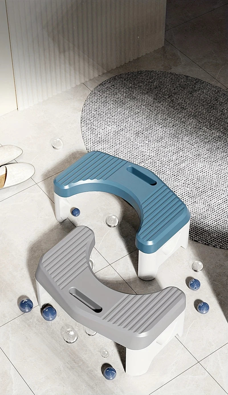 A light blue and white comfort squatting stool is shown on a tiled floor.