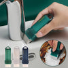 A hand holds a teal reusable limescale and stain eraser, showing its size and texture next to faucet components.