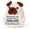 A light cream-colored crocheted plush dog ornament with brown floppy ears and a dark nose.