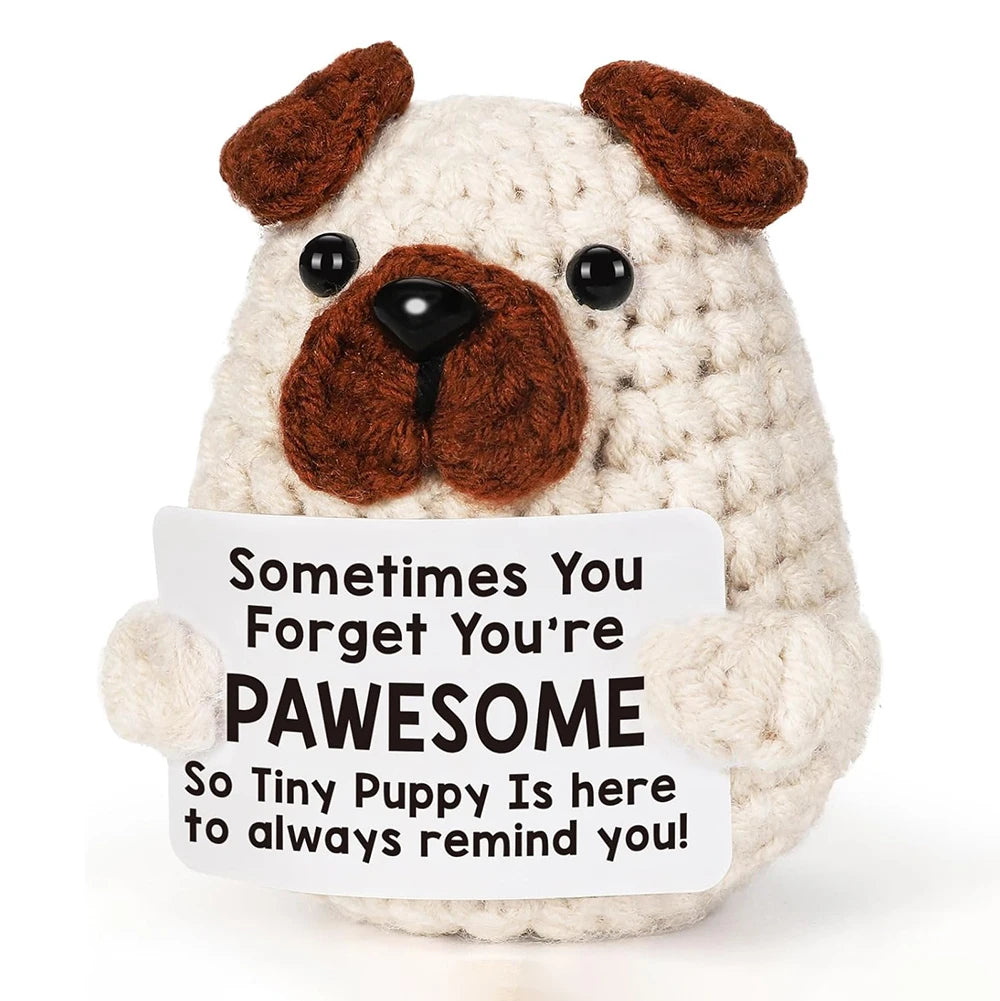 A light cream-colored crocheted plush dog ornament with brown floppy ears and a dark nose.