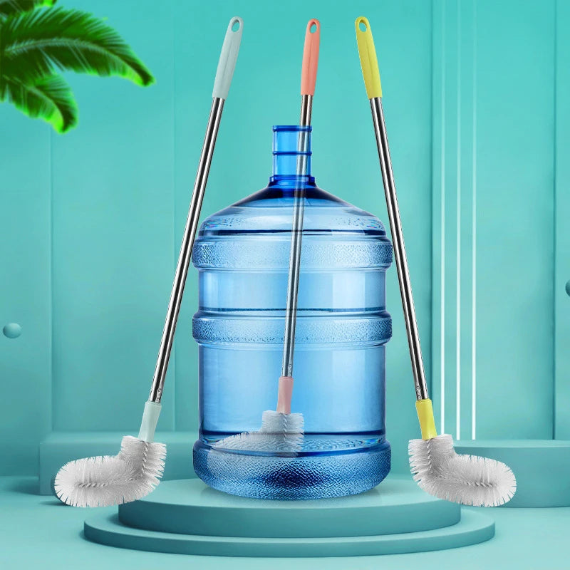 A blue plastic bucket is surrounded by three cleaning brushes with stainless steel and yellow handles on a light blue backgro